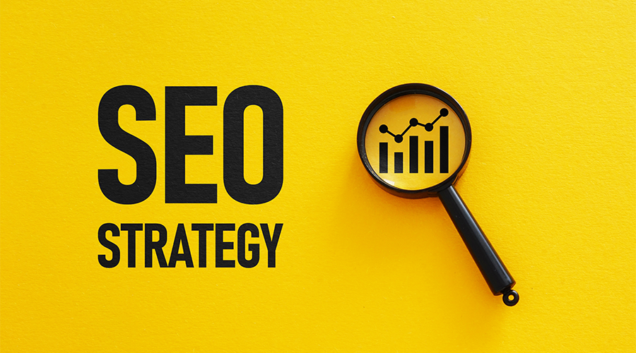 Es steht "SEO Strategy" auf gelb und daneben eine Lupe, die ein Diagramm vergrößert. Weiter Informationen zum Thema SEO Optimierung findest du im News Blog von cbba.